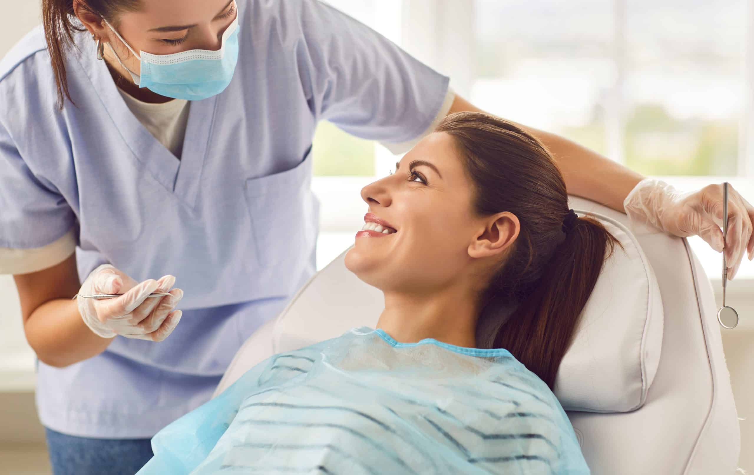 Dentist near me Kansas City performing dental examination with nurse and doctor assisting